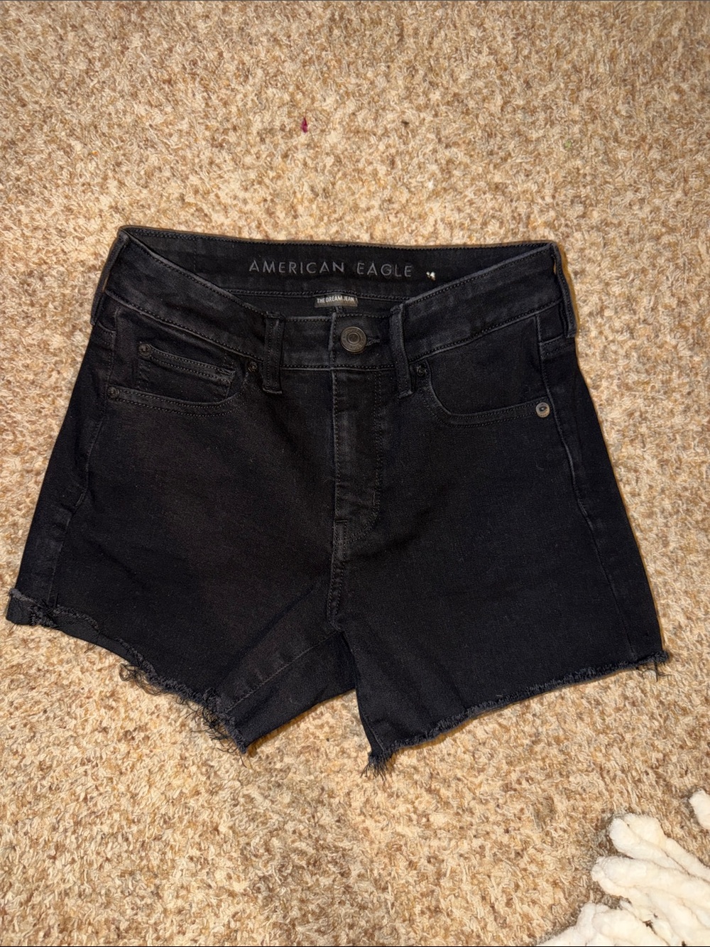 black American Eagle denim shorts feature a distressed, raw frayed hem size 4